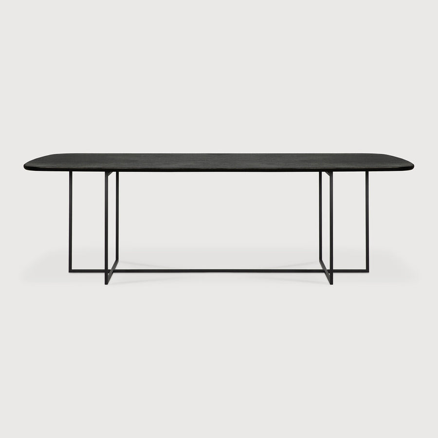 We love the combination of the tapered black metal leg base against a brushed black Oak finish on this Oak Arc Dining Table - Black.  With a slightly rounded tabletop, this brings a contemporary look to any dining room or kitchen area. Designed by Alain Van Havre.  Material: Oak, 100% Solid Wood Finish: Varnished