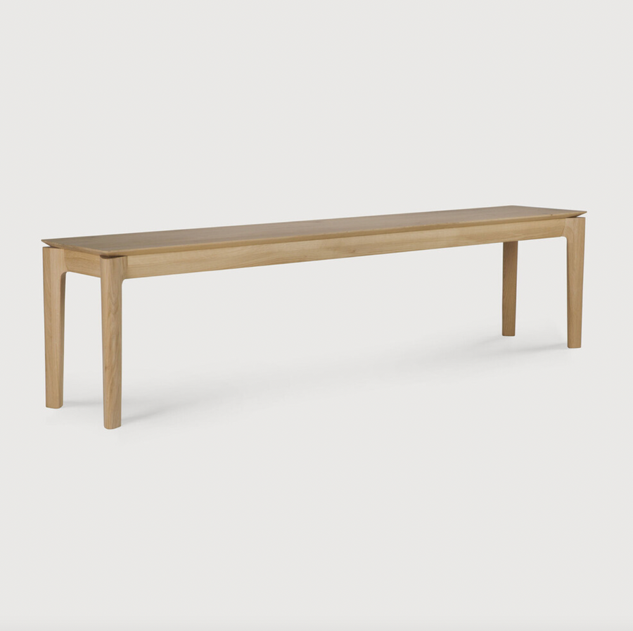 This Oak Bok Bench features an airy shape with rock-solid construction,  making this piece a timeless and remarkable design to enjoy for years to come. Pair with a dining table or stand-alone against a wall, hallway, or end of the bed!  Material: Oak Finish: Oiled