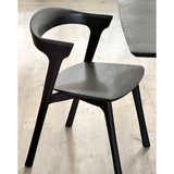 This Oak Bok Dining Chair features an airy shape with rock-solid construction, making this piece a timeless and remarkable design to enjoy for years to come. Pair with a dining table or stand-alone against a wall, hallway, or end of the bed! Designed by Alain can Havre Dimensions: 20"w x 21.5"d x 30"h Weight: 15 lbs Seat Height: 18" Seat Height with Upholstery: 19" Material: Oak, 100% solid wood Finish: Varnished