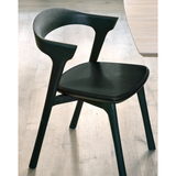 This Oak Bok Dining Chair features an airy shape with rock-solid construction,  making this piece a timeless and remarkable design to enjoy for years to come. Pair with a dining table or stand-alone against a wall, hallway, or end of the bed! Designed by Alain can Havre  Dimensions: 20"w x 21.5"d x 30"h  Weight: 15 lbs  Seat Height: 19"  Material: Oak, 100% solid wood Finish: Varnished