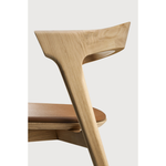 This Oak Bok Dining Chair features an airy shape with rock-solid construction,  making this piece a timeless and remarkable design to enjoy for years to come. Pair with a dining table or stand-alone against a wall, hallway, or end of the bed! Designed by Alain can Havre  Dimensions: 20"w x 21.5"d x 30"h  Weight: 15 lbs  Seat Height: 19"  Material: Oak, 100% solid wood Finish: Varnished