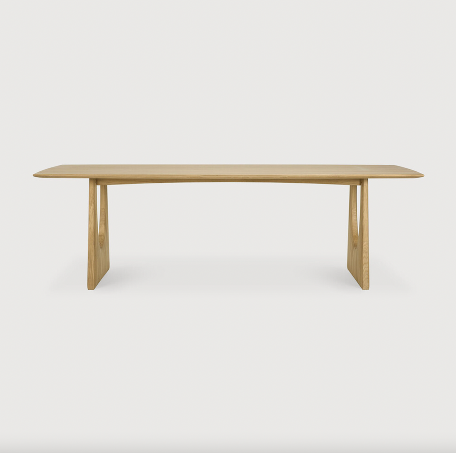 With enriched shapes and unexpected details, this Oak Geometric Dining Table is a statement item. Luxury comes with its length, which is offset by softened edges and natural lines -- perfect for any dining room or workspace.   Material: Oak, 100% Solid Wood Finish: Oiled