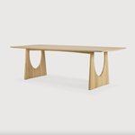 With enriched shapes and unexpected details, this Oak Geometric Dining Table is a statement item. Luxury comes with its length, which is offset by softened edges and natural lines -- perfect for any dining room or workspace.   Material: Oak, 100% Solid Wood Finish: Oiled