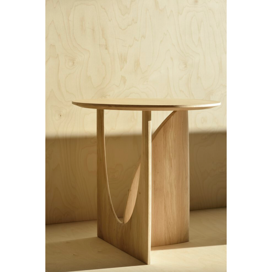 From any angle, the Oak Geometric Side Table does not only look different, it also becomes different. We love seeing this table as a sculptural accent to your living space or office.  Designed by Alain van Havre  Dimensions: 20.5"w x 20.5"d x 20"h  Weight: 11 lbs  Material: Oak Finish: Varnished