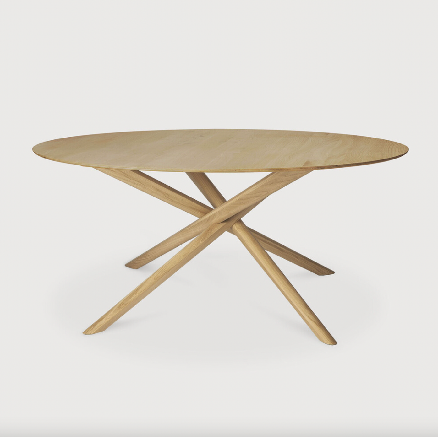 We love the sculptural character of this Oak Mikado Dining Table - Round. The legs interlock like a well-thought-out puzzle, making it easier to interact with your guests and allows you to converse with your family and friends for years to come!  Designed by Alain van Havre  Material: Oak, 100% Solid Wood Finish: Oiled