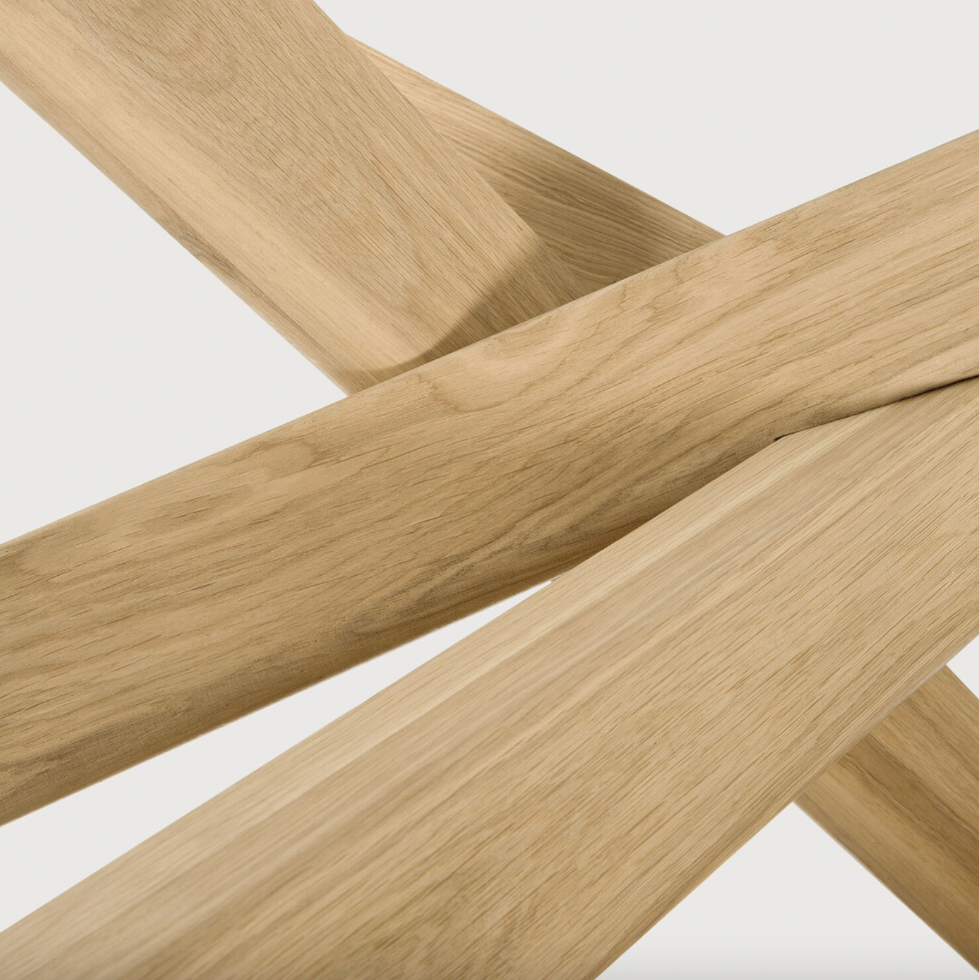 We love the sculptural character of this Oak Mikado Dining Table - Round. The legs interlock like a well-thought-out puzzle, making it easier to interact with your guests and allows you to converse with your family and friends for years to come!  Designed by Alain van Havre  Material: Oak, 100% Solid Wood Finish: Oiled