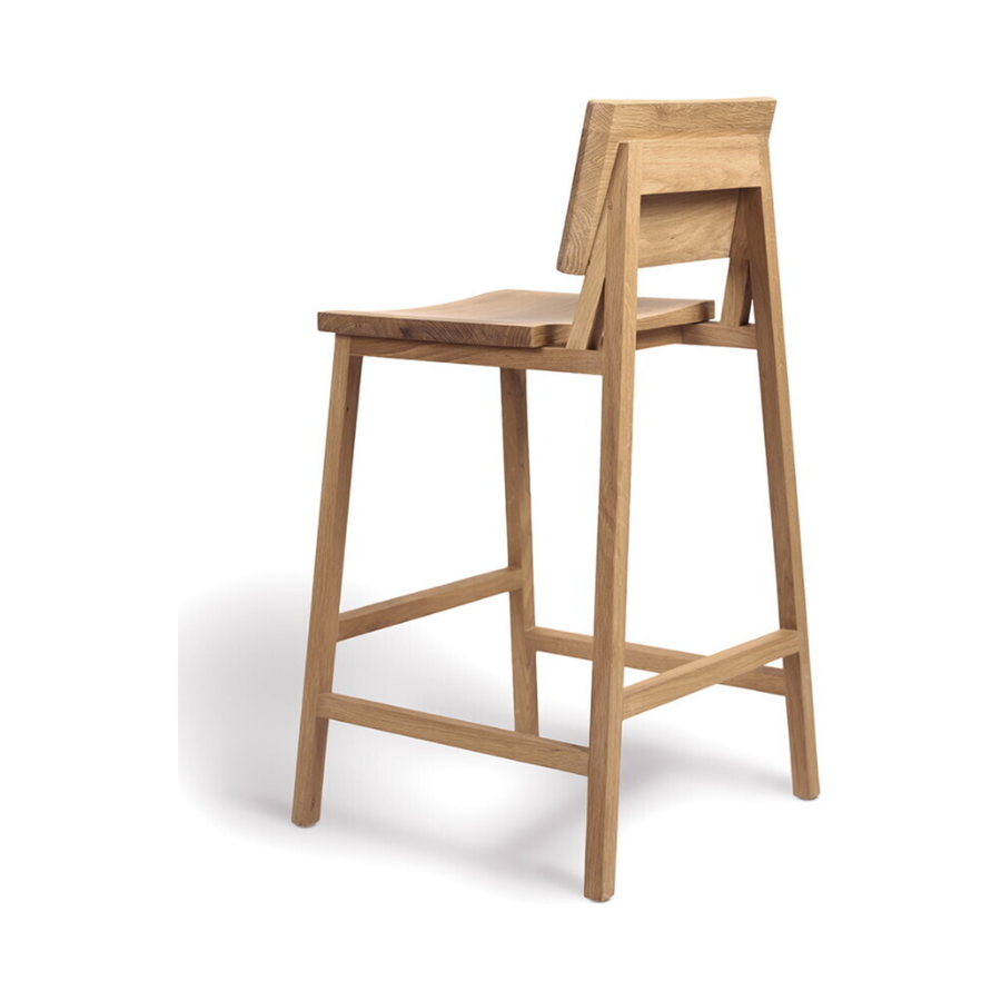We love the versatility of this Oak N3 counter stool. Designed by Nathan Yong, this stool is a timeless piece that adds both modern lines and a cozy organic aesthetic to your bar area or kitchen island.  Dimensions: 19.5"w x 20"d x 36"h Seat Height: 26"  Material: Oak, 100% Solid Wood Finish: Oiled 