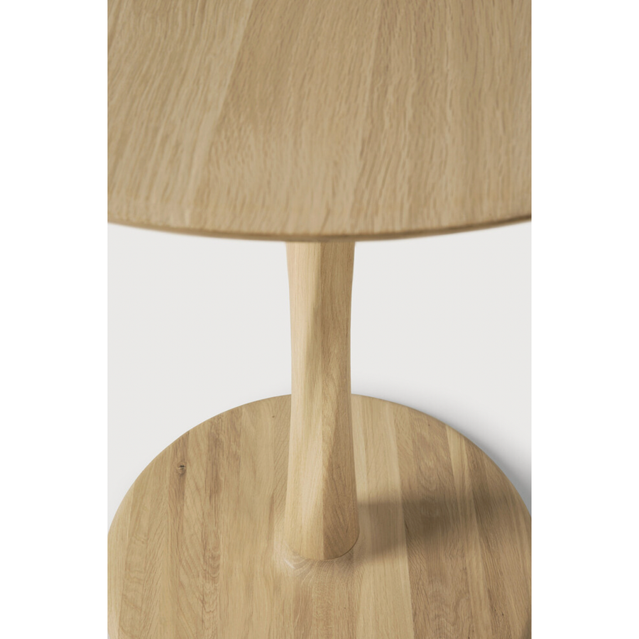 Airy with subtle complexities, this Oak Round Torsion Dining Table incorporates advanced woodworking techniques to create a light table top with a torsaded base of sculptural elegance -- sure to elevate the look for any dining or kitchen area.   Material: Oak, 100% Solid Wood Finish: Varnished