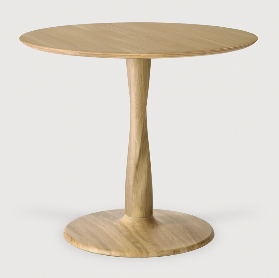 Airy with subtle complexities, this Oak Round Torsion Dining Table incorporates advanced woodworking techniques to create a light table top with a torsaded base of sculptural elegance -- sure to elevate the look for any dining or kitchen area.   Material: Oak, 100% Solid Wood Finish: Varnished