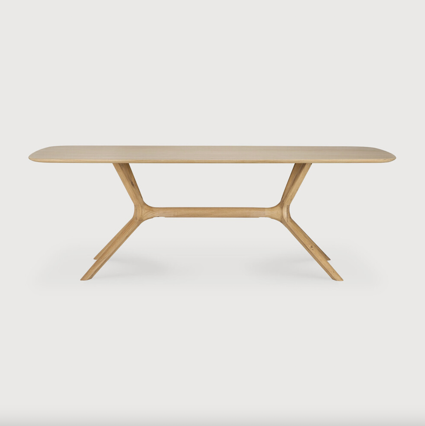 This Oak X Dining Table features sturdy, intricate construction of advance wood working. With a seamless structural interplay between the unique shape of the legs and the soft lines of the tabletop, guests will enjoy the most comfortable seating experience.  Designed by Alain van Havre Finish: Oiled