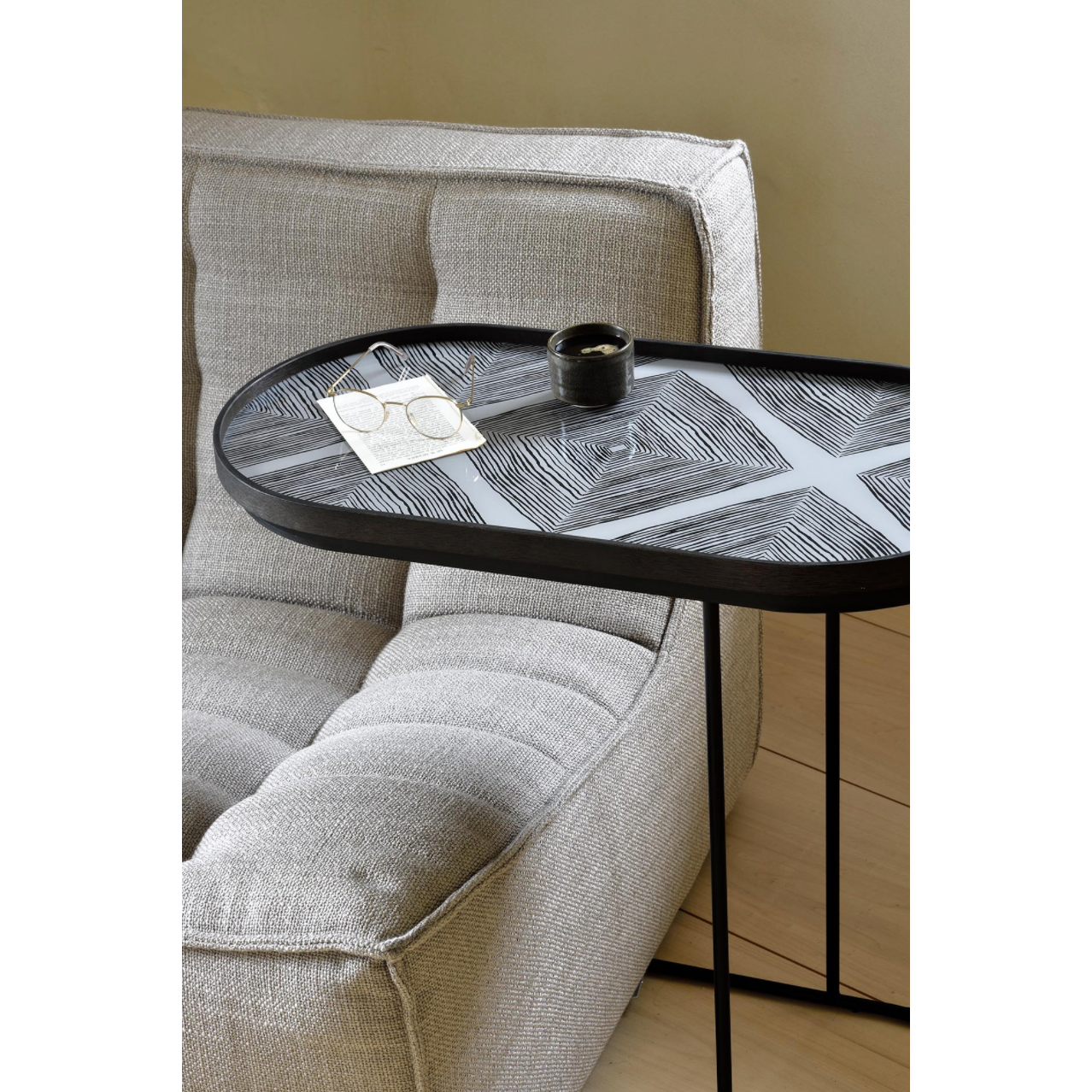 We love that this Oblong Tray Side Table has the ability to adopt different trays to mix or match various colors and patterns, creating a personal piece that is uniquely yours!  Dimensions: 27.5"w x 13"d x 26"h   Material: Metal 