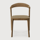 This Teak Bok Dining Chair features an airy shape with rock-solid construction,  making this piece a timeless and remarkable design to enjoy for years to come. Pair with a dining table or stand-alone against a wall, hallway, or end of the bed! Designed by Alain can Havre  Dimensions: 20"w x 21.5"d x 30"h  Weight: 12 lbs  Seat Height: 18"  Material: Oak, 100% solid wood Finish: Varnished