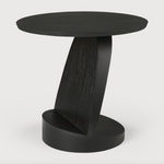 We love the unique base of this Teak Oblic Side Table - Black. Place near your sofa, bed side table, or accent chair to completely elevate the space!  Dimensions: 20.5"w x 20.5"d x 19.5"h  Weight: 21 lbs  Material: Teak, 100% Solid Wood Finish: Varnished