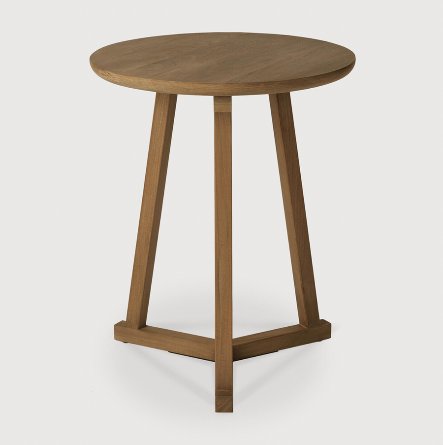 We love the versatility of this Teak Tripod Side Table. This can be placed next to a sofa, used as a bedside table, or grouped together with multiple tables for an interesting look!  Dimensions: 18.5"w x 18.5"d x 22.5"h   Material: Teak  Finish: Oiled