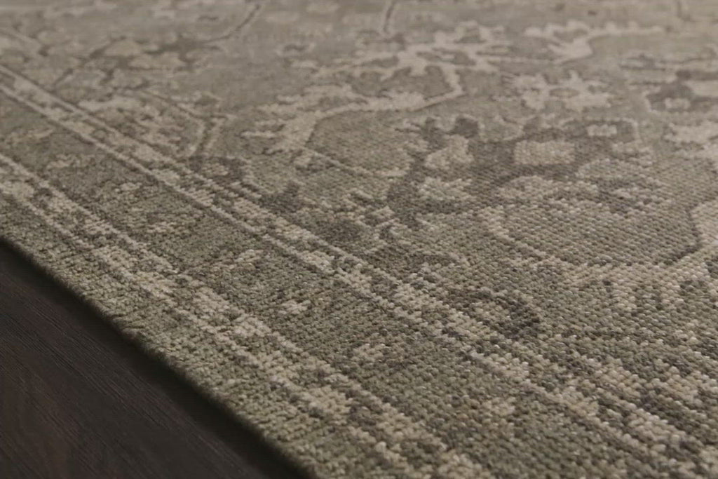 Bring a touch of antiqued beauty into your home with the Heirloom Fog / Fog Area rug from Loloi. This wool rug tastefully honors the art of hand knotted rugs. The rug evokes a sense of unique sophistication with its traditional Serapi rug color palettes and vintage design.  This rug would be perfect for a living room, dining room, bedroom, hallway or kitchen runner with it's patterns and calming tones for your home.  Hand Knotted 83% Wool | 17% Cotton HQ-03 Fog / Fog