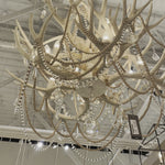 Rustic meets luxe vibe with this Cheyanne Antler Chandelier by Regina Andrew. The antlers matched with the tea stained crystals make a statement in any living room, entryway or other area needing extra light.   Overall size: 40"h x 33"w x 33"d