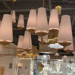 The Fontaine Large Offset Chandelier by Visual Comfort has a slim cross section at the bottom matched with offset layers of linen shades. This is a gorgeous piece to add to any dining room, living room, or other large area.   Designer: AERIN