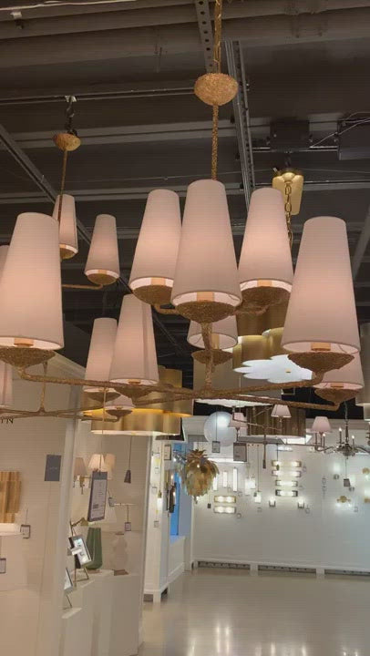 The Fontaine Large Offset Chandelier by Visual Comfort has a slim cross section at the bottom matched with offset layers of linen shades. This is a gorgeous piece to add to any dining room, living room, or other large area.   Designer: AERIN