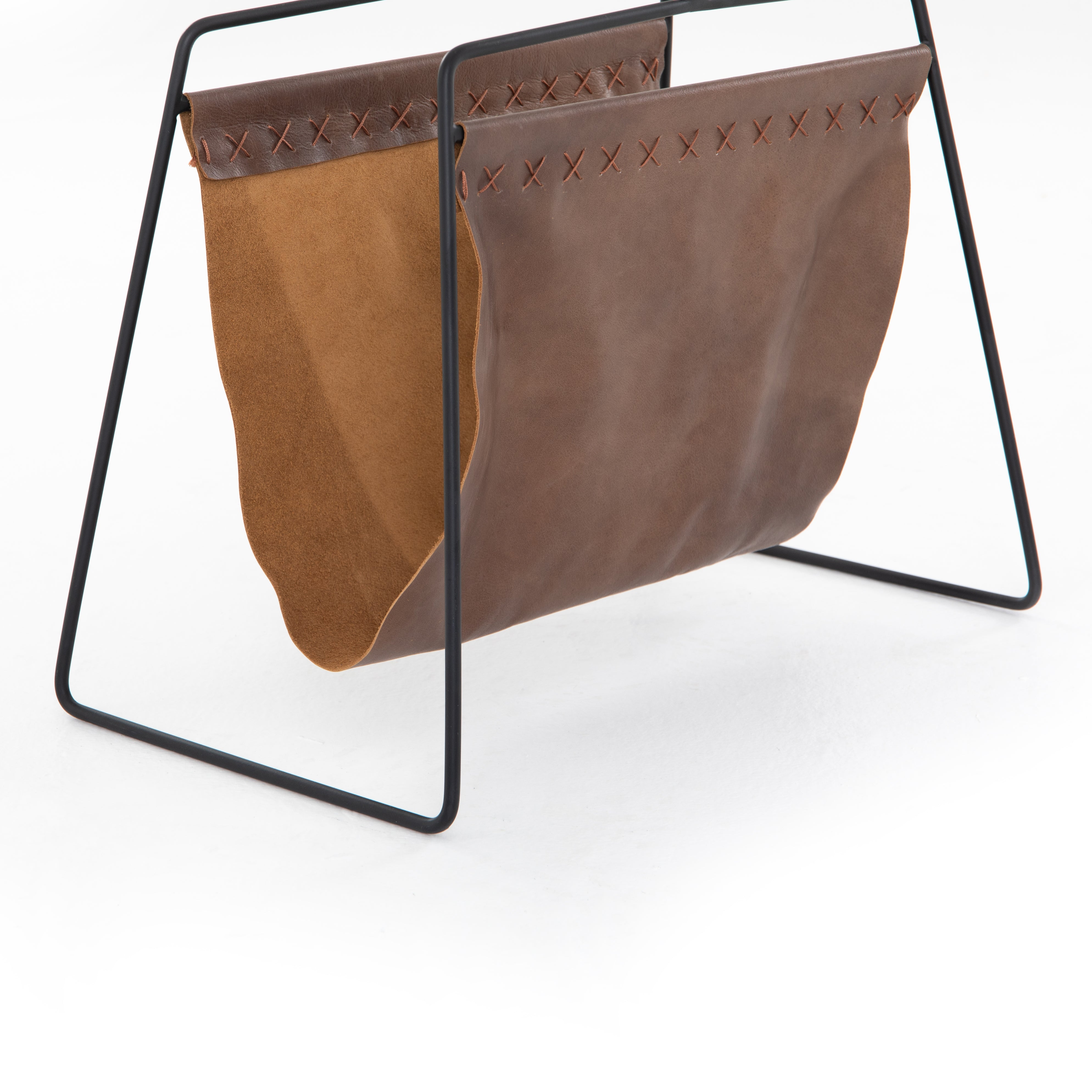 We love the cross-stitching details on this patina brown, top grain leather Aesop Magazing Rack. A gorgeous piece to place all your favorite magazines or important papers in, while also bringing a stylish mid-century vibe to your office or other space.  Overall Dimensions: 18.50"w x 11.75"d x 19.00"h Materials: Top Grain Leather, Iron Colors: Patina Brown, Smooth Jet Black
