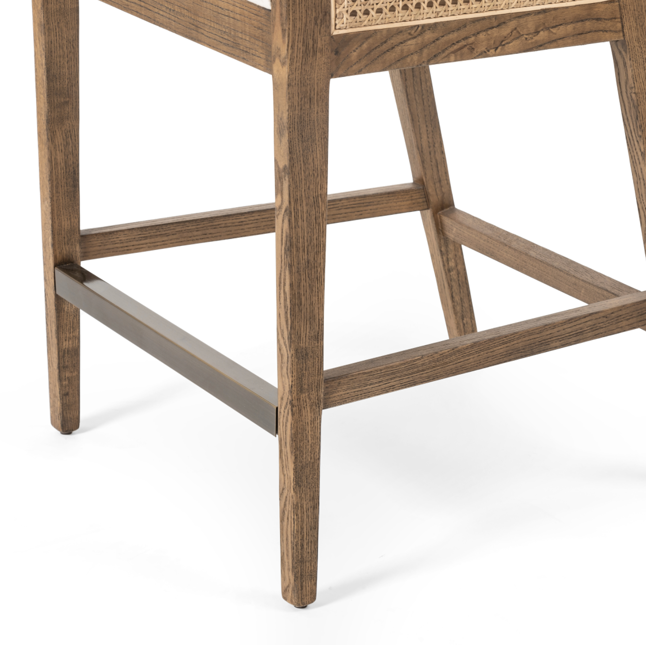 We love the retro look the cane brings to this Antonia Bar + Counter Stool - Toasted Nettlewood. A stunning piece to complete a retro or boho aesthetic in any kitchen or bar area.   Counter Stool Overall Dimensions:  22.00"w x 22.50"d x 39.00"h Seat Depth: 18.5" Seat Height: 26" Arm Height from Floor: 33.25" Arm Height from Seat: 7.25"  Colors: Natural Cane, Toasted Nettlewood, Brass Kickplate, Savile Flax Materials: Cane, Solid Nettlewood, Iron, 92% Pl, 8% Li