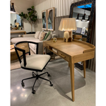 With dramatically tapered legs and a slender silhouette, this Armstrong Desk - Burnished Oak is made of light-burnished oak and places a femme, functional twist on mid-century styling. Dual drawers plus an open center cubby for handy office supply storage.  Overall Dimensions: 55.50"w x 27.00"d x 32.00"h