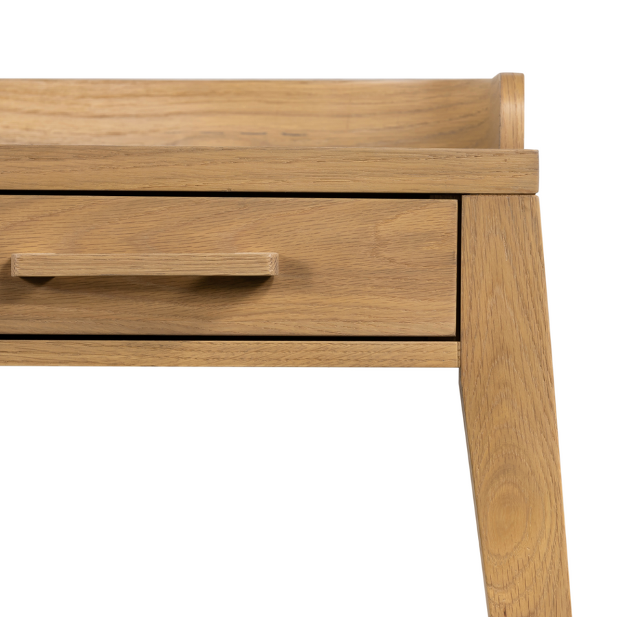 With dramatically tapered legs and a slender silhouette, this Armstrong Desk - Burnished Oak is made of light-burnished oak and places a femme, functional twist on mid-century styling. Dual drawers plus an open center cubby for handy office supply storage.  Overall Dimensions: 55.50"w x 27.00"d x 32.00"h