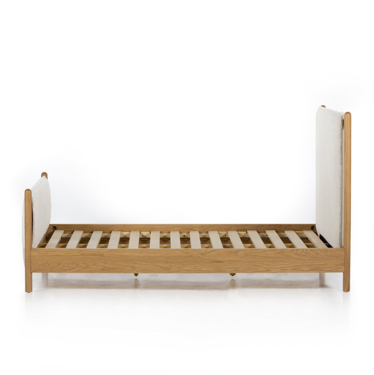 Bring a cozy hygge vibe to the bedroom with this textured Bowen Bed. Framed by light-finished solid oak, a sling-style bed features faux shearling head and foot boards -- sure to elevate any bedroom.   Queen Overall Dimensions: 64.25"w x 87.25"d x 48.00"h King Overall Dimensions: 80.25"w x 88.50"d x 48.00"h