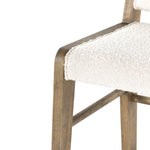 We love the mixed materials found in this Charon Bar + Counter Stool. In a light, natural finish, solid parawood forms an angular frame for boucle-upholstered seating in a classic cream.