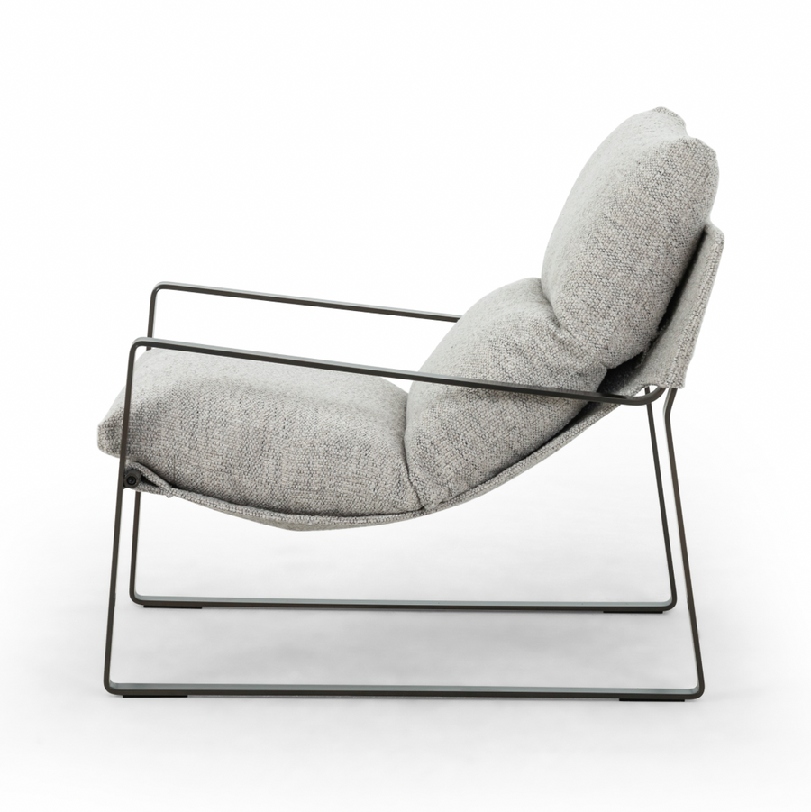 Super stylish, effortlessly cool, this Emmett Sling Chair - Merino Porcelain is upholstered with beautifully chunky seagrass texture and a sling-style seating that sits low and curved for a fresh take on a throwback form. Industrial gunmetal-finished iron framing turns up the drama one more notch for any living room, office, or other space.   Overall Dimensions: 29.00"w x 36.00"d x 29.00"h