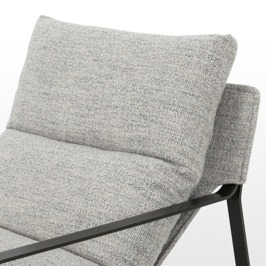 Super stylish, effortlessly cool, this Emmett Sling Chair - Merino Porcelain is upholstered with beautifully chunky seagrass texture and a sling-style seating that sits low and curved for a fresh take on a throwback form. Industrial gunmetal-finished iron framing turns up the drama one more notch for any living room, office, or other space.   Overall Dimensions: 29.00"w x 36.00"d x 29.00"h