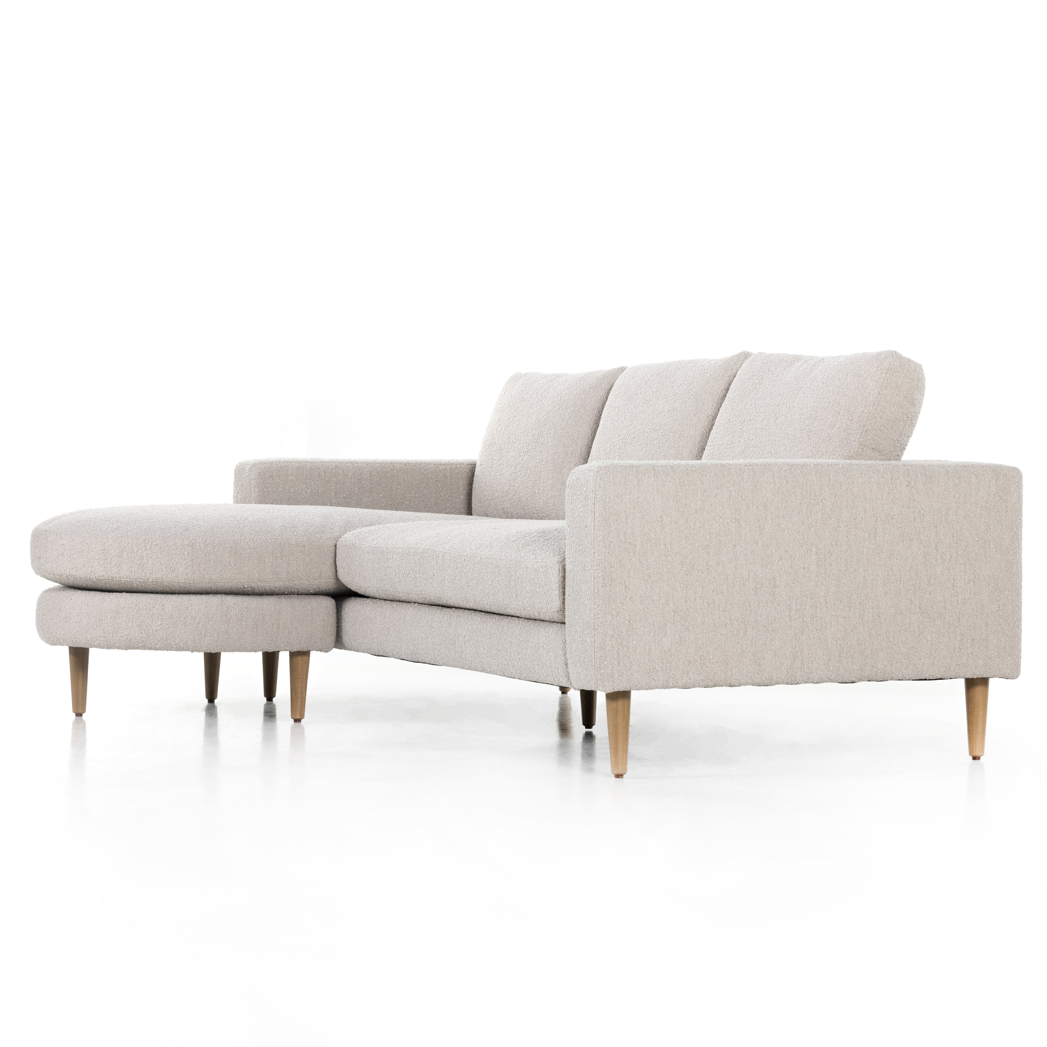 Fun while sophisticated, the option to flip the direction of this Freya Flip Sofa - 97" - Knoll Sand delivers clever adaptability to the modern living room. Upholstered in a textural boucle, cone-tapered wooden legs add a sense of lightness to any living room or lounge area.  Overall Dimensions: 96.00"w x 64.00"d x 34.00"h