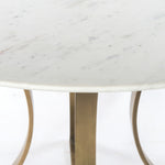 Featuring Gage Dining Table - Polished White Marble by Four Hands at Amethyst Home. Sophisticated materials take a cue from modern geometry. Cast brass iron forms uniquely-curved angles to balance a contrasting polished white marble top. A refined spin on trend-forward design.
Dimensions: 48"W x 48"L x 30"H, or 60"W x 60"L x 30"H 
Colors: Cast Brass, Polished.  Amethyst Home provides interior design, new home construction design consulting, vintage area rugs, and lighting in the Boston metro area.