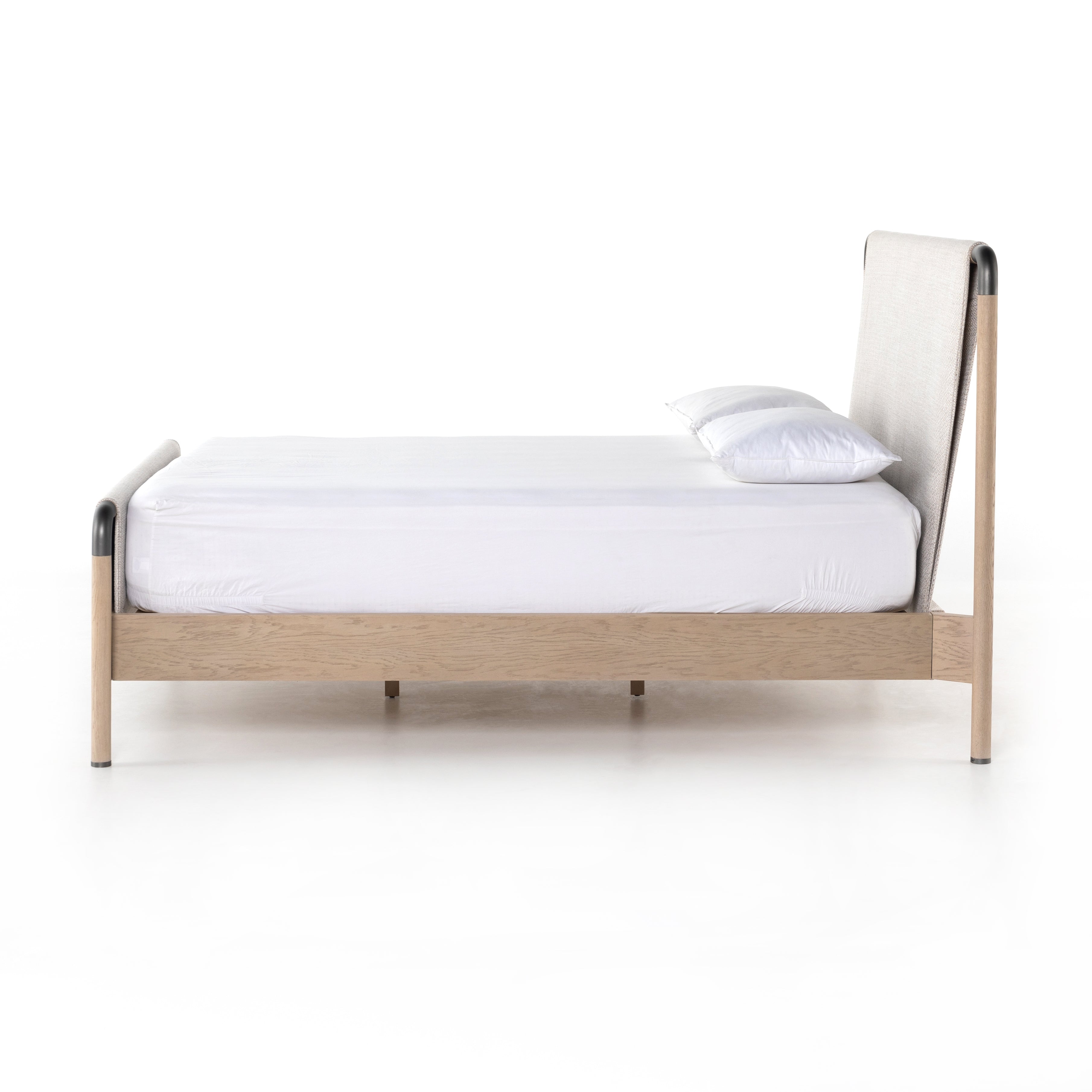 We love the mixed materials of this Harriet Bed. Framed by solid oak with rounded iron corners, an upholstered, sling-style headboard brings a light, modern vibe to any bedroom. Queen Overall Dimensions: 70.50"w x 88.50"d x 51.00"h  King Overall Dimensions: 86.50"w x 88.50"d x 51.00"h
