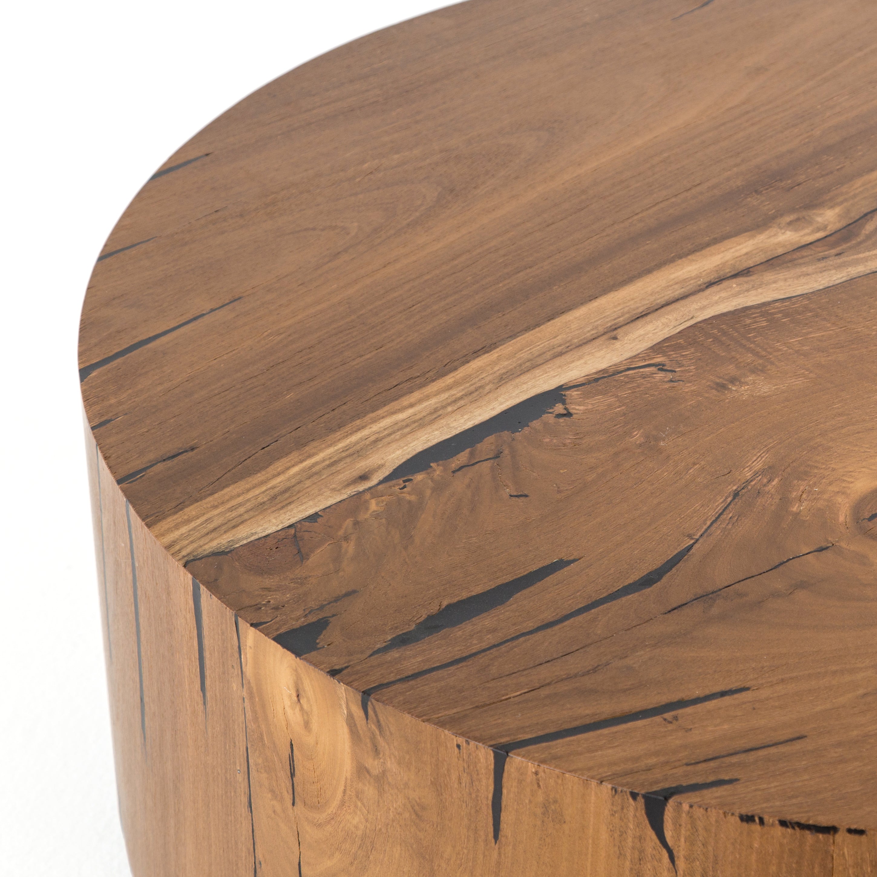 We love how the stunning forces of nature are captured in the Hudson Natural Yukas Coffee Table. Natural yukas wood is hand-shaped into a cylindrical silhouette and placed over a bronzed iron base to complete your living room space.   Overall Dimensions: 40"w x 40"d x 15"h  Colors: Natural Yukas Resin, Gunmetal Materials: Thick Yukas Veneer, Iron
