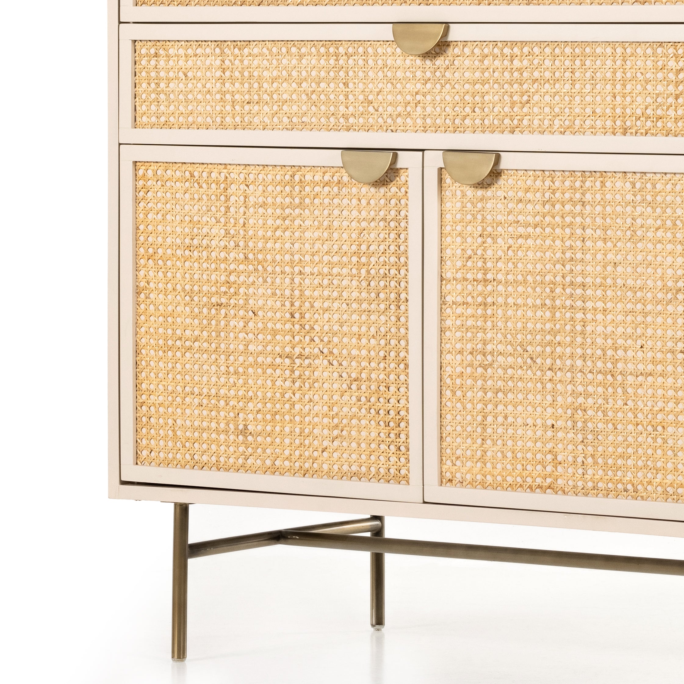 Bring a light look to bedroom styling with this Luella Tall Dresser - Matte Alabaster. A tall, lacquered dresser features woven cane panels and half-moon hardware finished in an aged brass. Four drawers plus cabinetry with interior shelving for generous storage space for any bedroom!   Overall Dimensions: 38.00"w x 19.00"d x 50.00"h