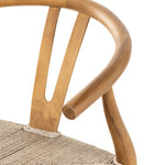 Modern curves redefine classic wishbone seating in this Muestra Dining Chair - Natural Teak. Vintage white all-weather wicker is woven for a dose of fresh texture against a neutral frame of natural teak. Cover or store indoors during inclement weather and when not in use.  Overall Dimensions: 21.50"w x 22.50"d x 31.50"h