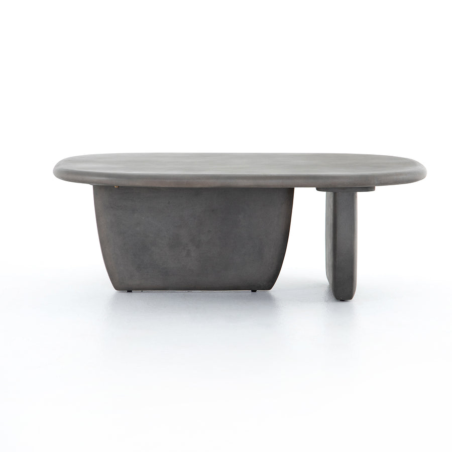 This Naya Outdoor Coffee Table is modern and curve-driven. Dark grey concrete forms a rounded rectangle top with bullnose edging, reminiscent of a shapely surfboard.  Cover or store inside during inclement weather.  Overall Dimensions: 46.00"w x 28.00"d x 16.00"h
