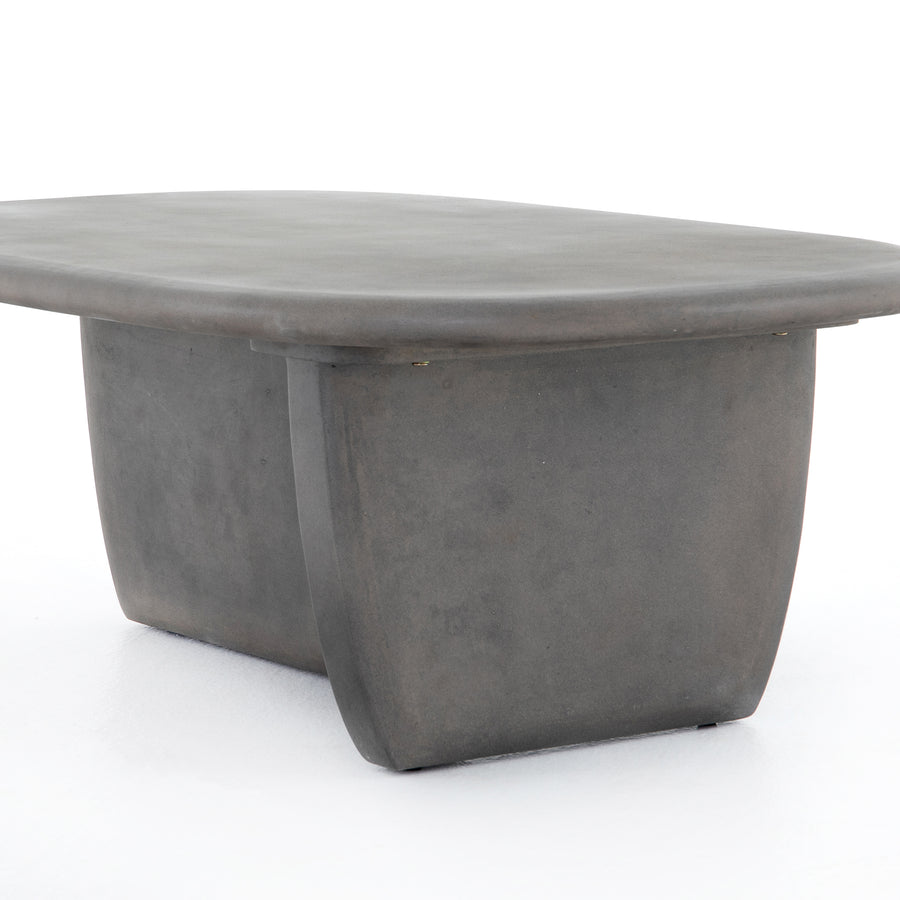 This Naya Outdoor Coffee Table is modern and curve-driven. Dark grey concrete forms a rounded rectangle top with bullnose edging, reminiscent of a shapely surfboard.  Cover or store inside during inclement weather.  Overall Dimensions: 46.00"w x 28.00"d x 16.00"h