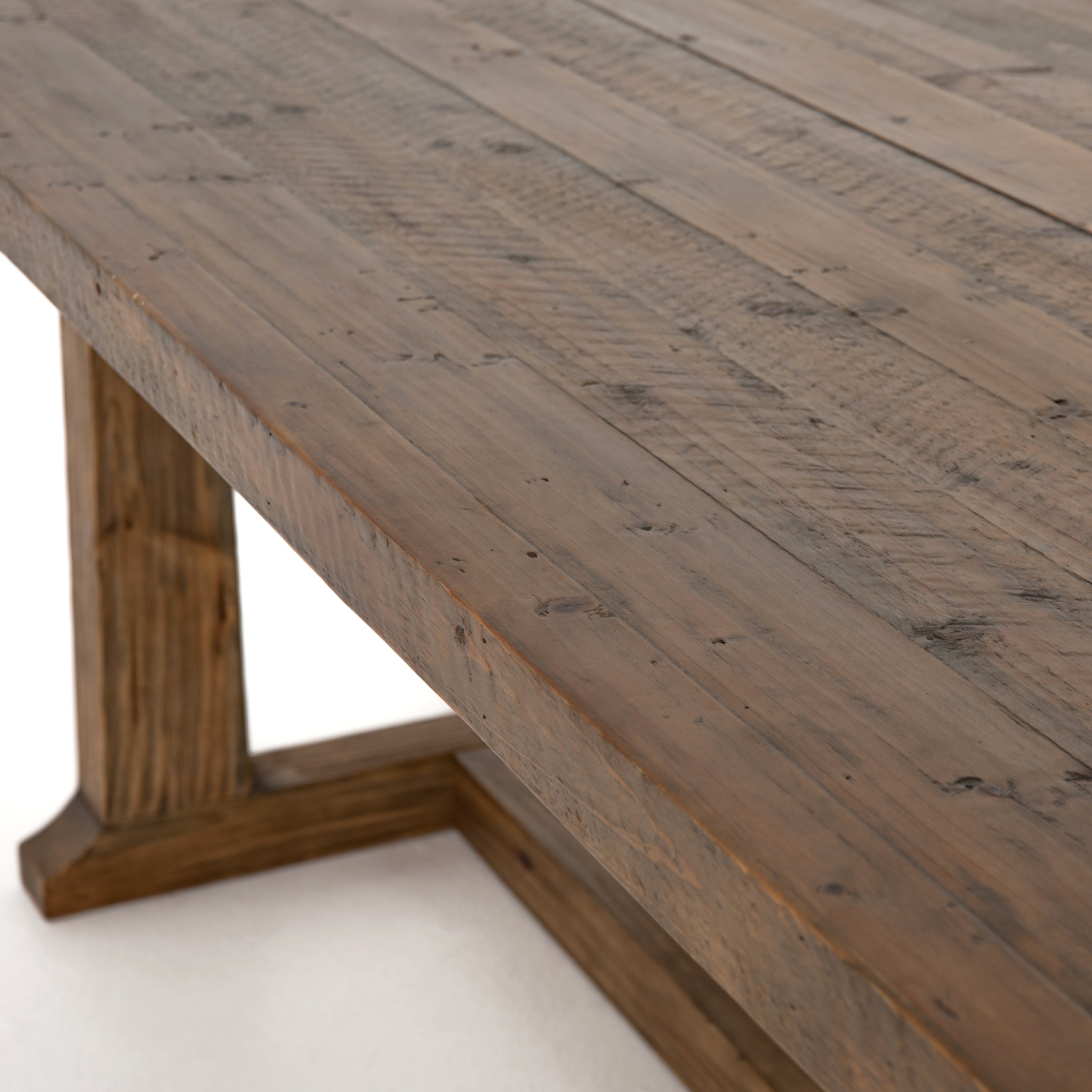 Bring a traditional sense to the table with this Otto Dining Table - 110". Finished in a warm honey hue, a trestle-style base of reclaimed pine supports a rectangular top of pine, waxed and bleached for a rustic look with natural depth.