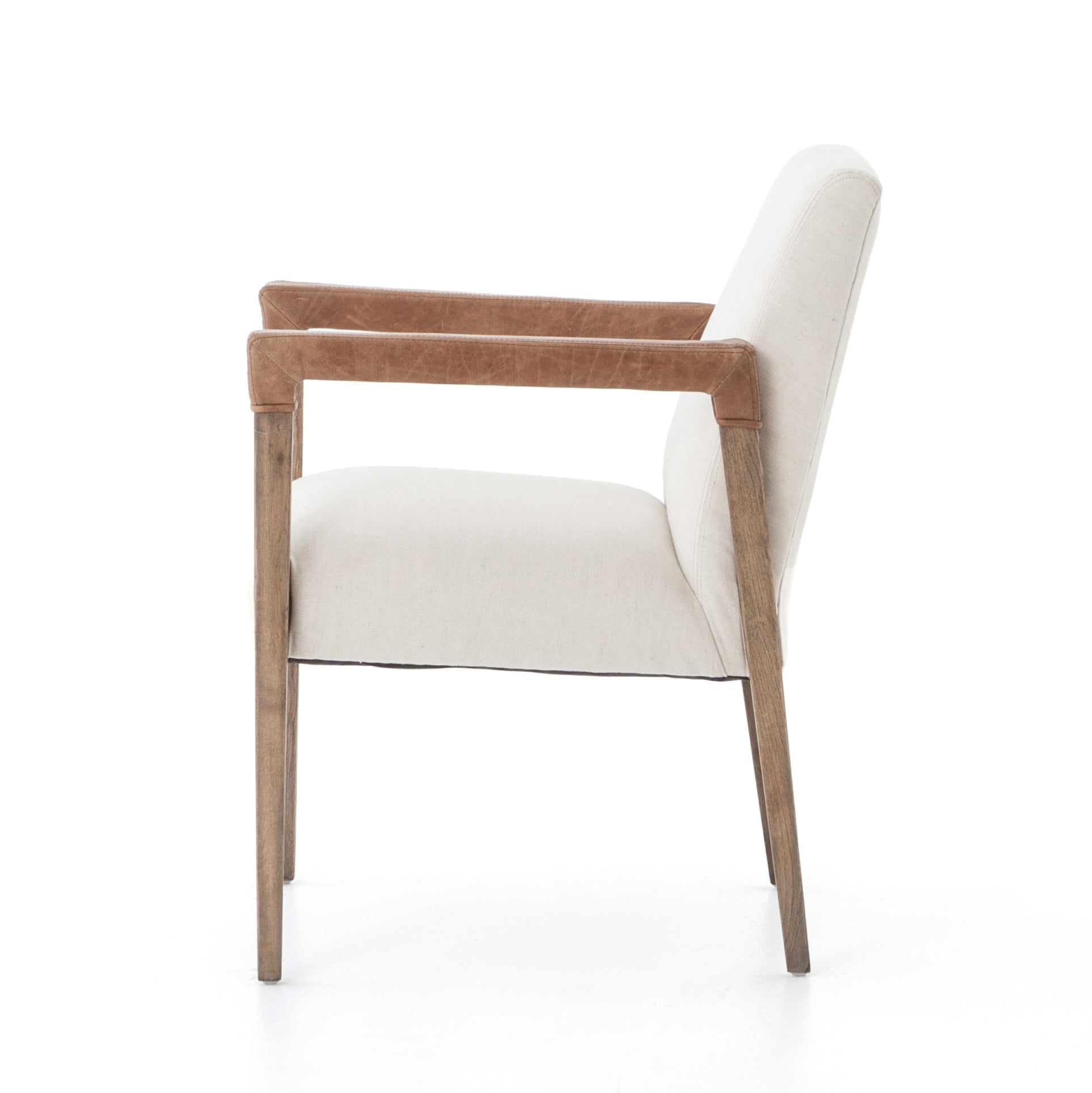 Elegance is no exaggeration with this Reuben Dining Chair - Harbor Natural. Slim, tapered oak with arms wrapped in vintage leather frames a floating seat covered in natural linen. We'd love to see this in your dining room, kitchen, or other space!  Overall Dimensions: 23.25"w x 25.50"d x 33.75"h