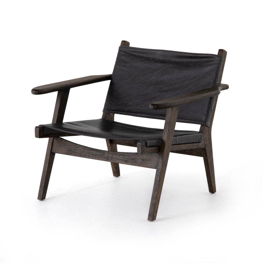 Low, cool, and casual with this Rivers Sling Chair - Sonoma Black. Sling seating of black top-grain leather is framed by warm-finished parawood, for an edgy, effortless look for any office, living room, or other area.   Overall Dimensions: 31.50"w x 31.00"d x 28.75"h