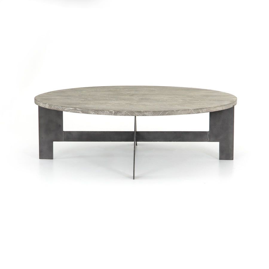 We love the thin iron gunmetal legs of this Round Coffee Table with Iron. The charcoal tones bring a neutral tone to any living room or lounge area.   Overall Dimensions: 48.00"w x 48.00"d x 15.50"h   Colors: Gunmetal, Charcoal Materials: Iron, Mango Wood Weight: 75.51 lb