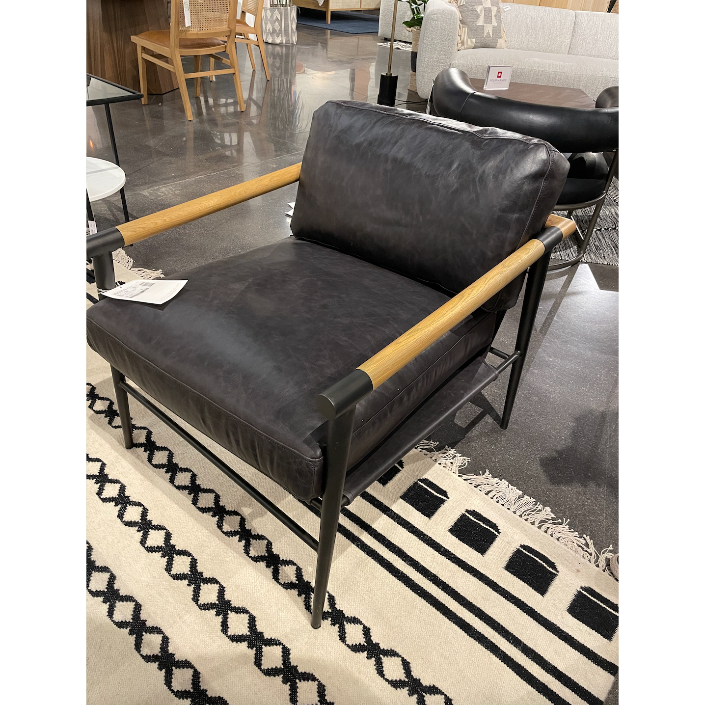 This Rowen Chair - Sonoma Black has buttery black seating of top-grain leather, with angular arms of exposed oak providing fresh contrast. A comfy, modern chair to add to any living room, bedroom, or other area.   Overall Dimensions: 27.50"w x 32.00"d x 31.00"h