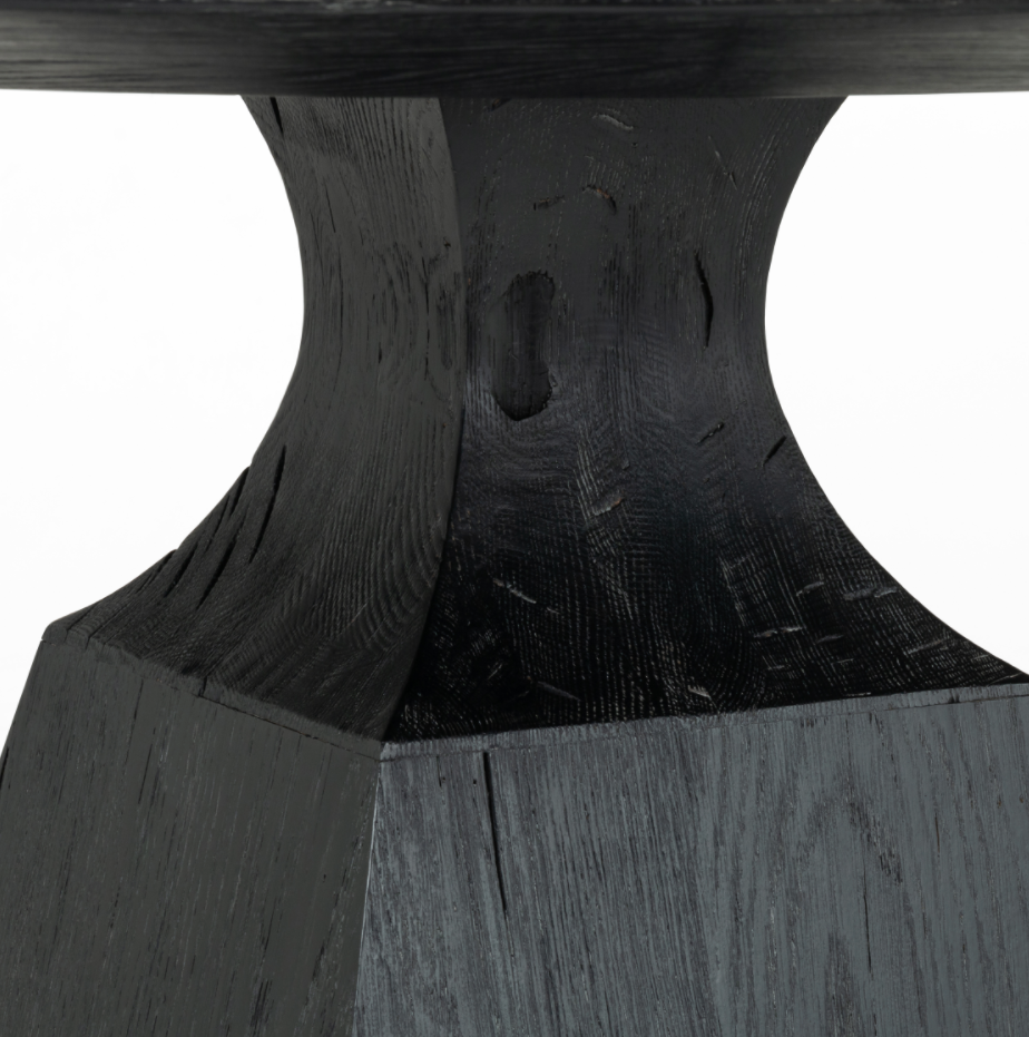 We love the unique bell shape of this Sargon Bluestone Dining Table. It brings an industrial feel to any dining room.   Size: 53.25"w x 53.25"d x 30"h  Colors: Washed Black, Bluestone Materials: Solid Oak, Bluestone