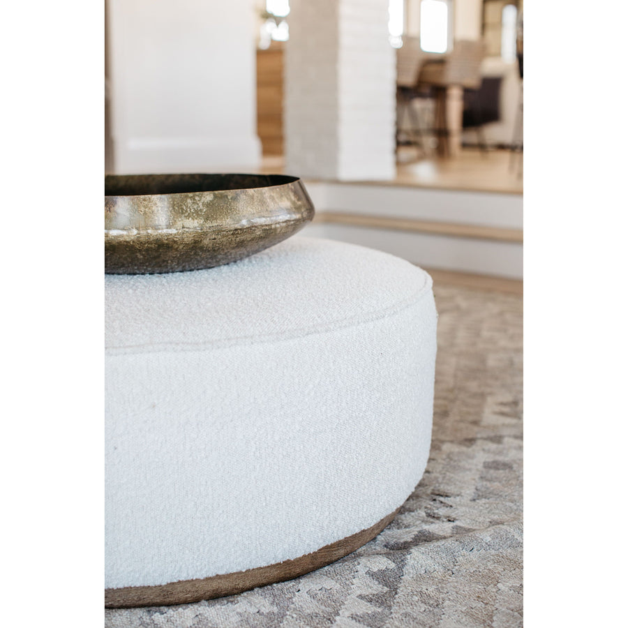 This round ottoman of textural cream boucle can be placed just about anywhere, bringing with it a hip retro vibe.  Overall Dimensions: 36"w x 36"d x 14.5"h