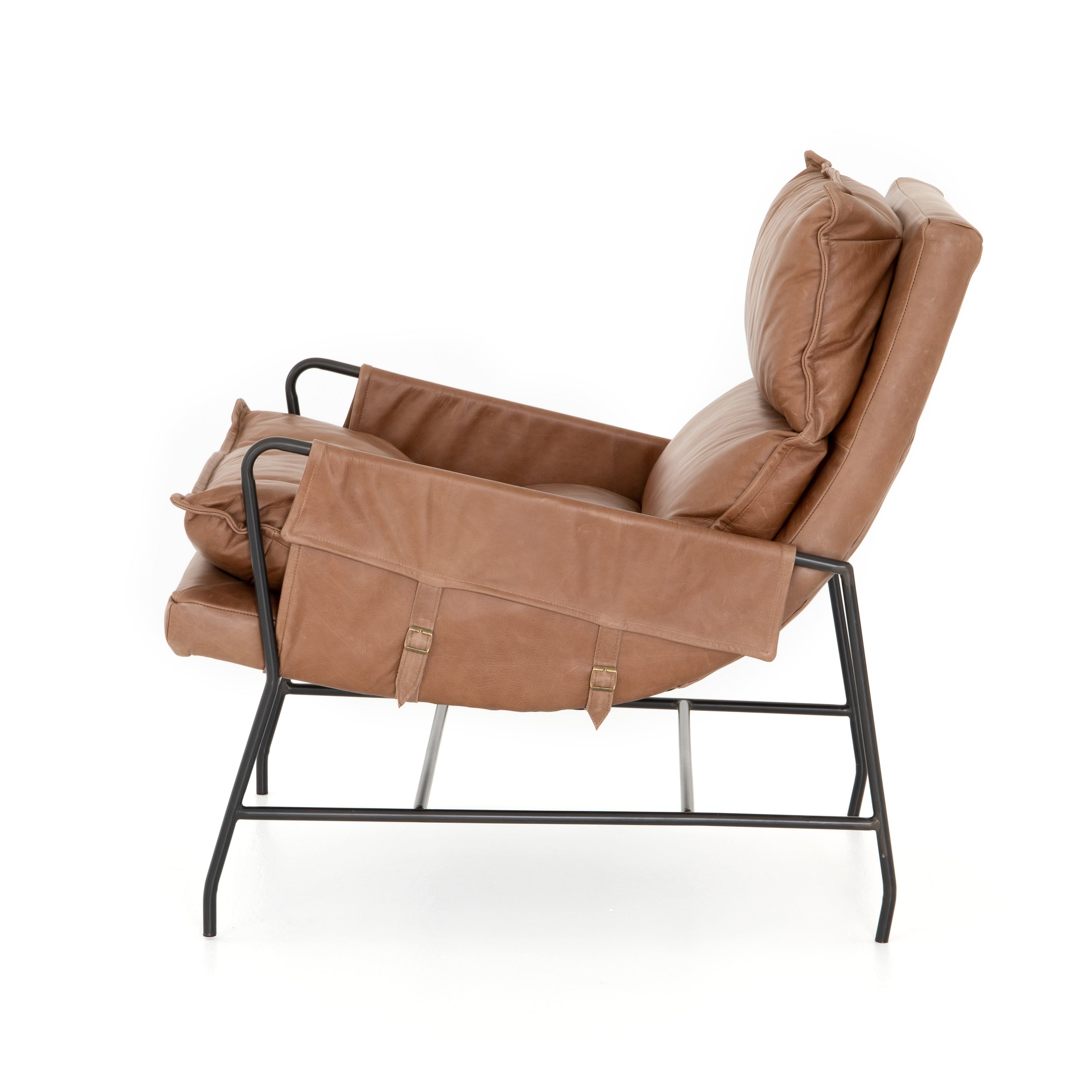 A nod to relaxed modernism, playing up the natural depth of exclusive top-grain leather, with buckle details and low-slung styling crafting the hippest of vibes.  Overall Dimensions: 28.00"w x 37.00"d x 35.00"h Seat Depth: 22" Seat Height: 20" Arm Height from Floor: 23.5" Arm Height from Seat: 3.5"  Colors: Waxed Ebony, Chaps Saddle Materials: Iron, Top Grain Leather