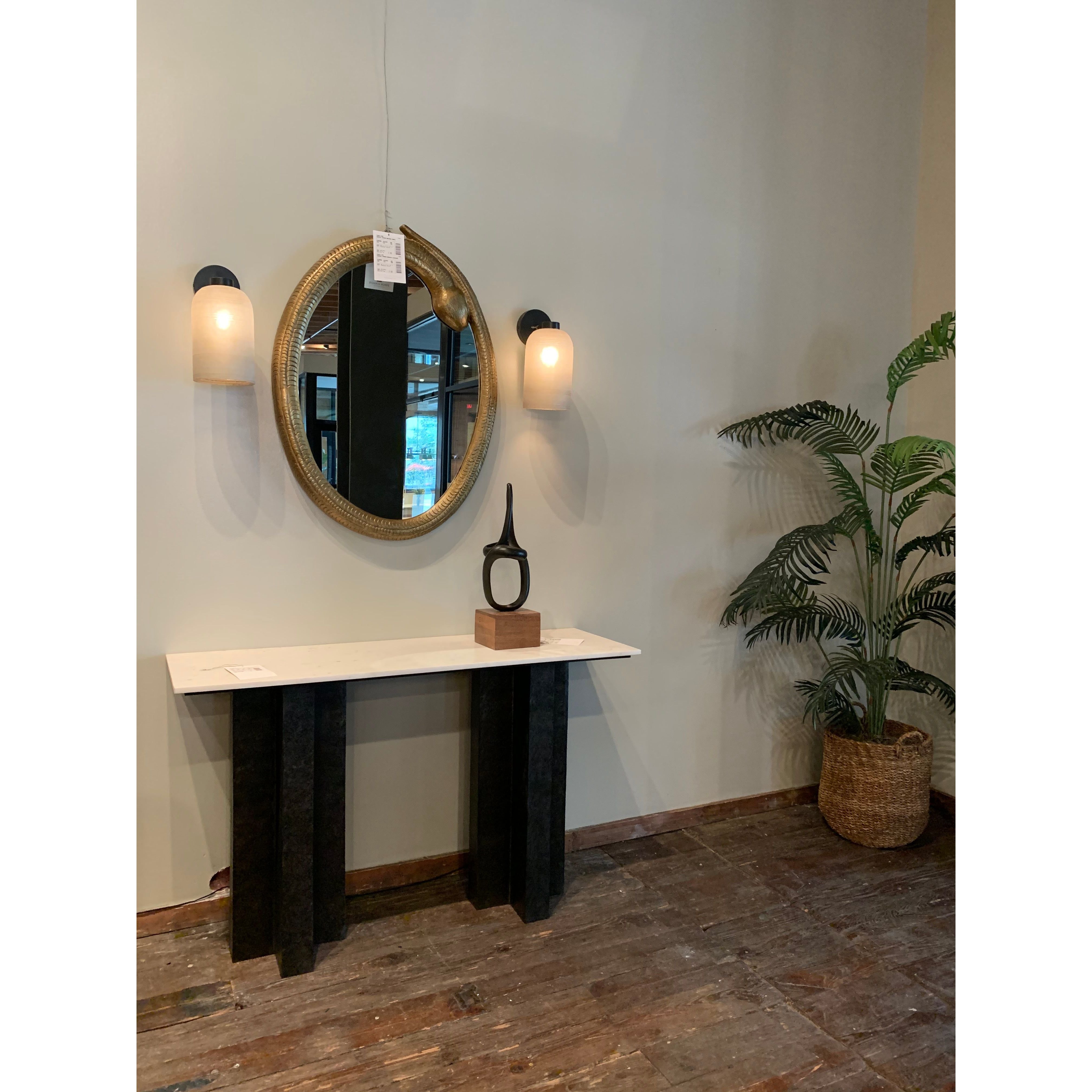 Finished in a raw black, uniquely angular cast aluminum legs, this Terrell Console Table - Raw Black showcases a rectangular tabletop of solid marble in a clean, polished white. We'd love to see this in an entryway or behind a sofa.   Overall Dimensions: 51.00"w x 17.00"d x 31.25"h
