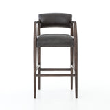 The Tyler Bar + Counter Stool - Ebony makes counter seating stylish with an angular, dark and smoky birch frame, a deep seat, and a striking, low-slung back. The stool is comfortable for long dinners and conversations with a covered black, top-grain leather seat and back.