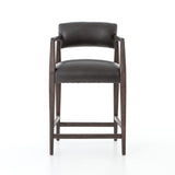 The Tyler Bar + Counter Stool - Ebony makes counter seating stylish with an angular, dark and smoky birch frame, a deep seat, and a striking, low-slung back. The stool is comfortable for long dinners and conversations with a covered black, top-grain leather seat and back.