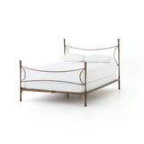 Beguiling curves soften hard materials for marked drama with this Westwood Bed. Slim, hammered iron is finished in antique brass for depth that defies this frame's feminine air. Low-profile box spring recommended.